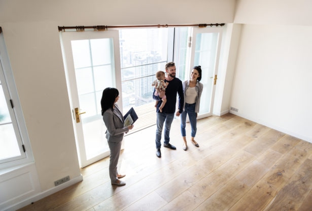 Family reviewing new home with real state agent