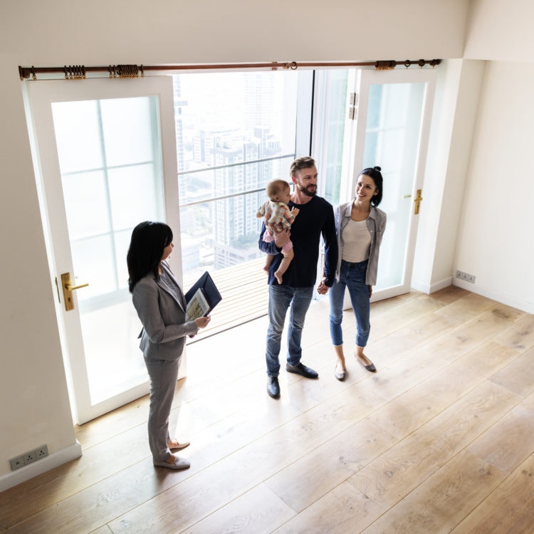 Family reviewing new home with real state agent