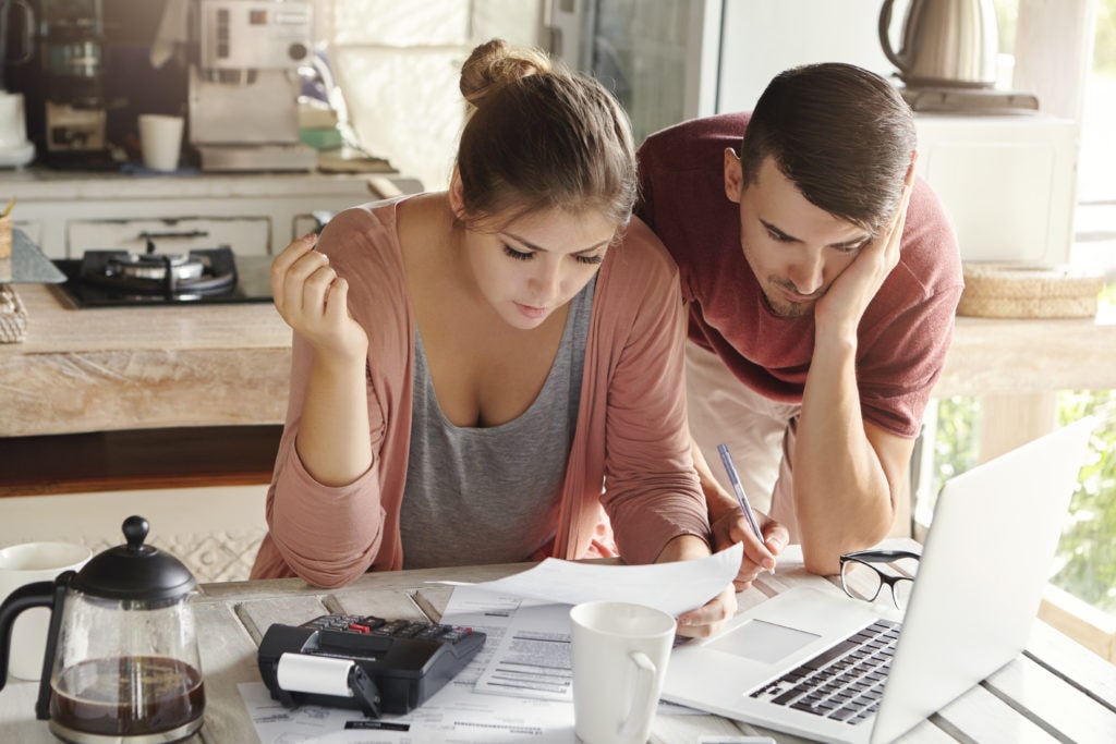 Young couple calculating their mortgage payments