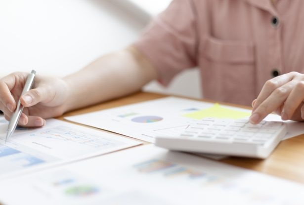 Accounting businesswomen are calculating savings