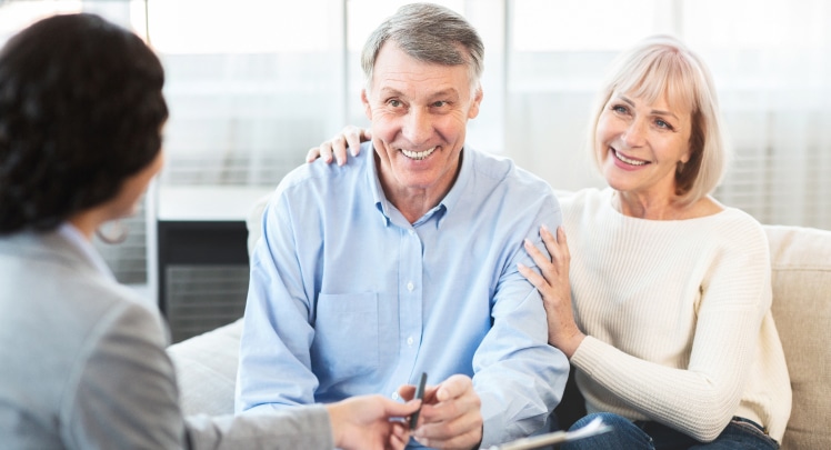 Older couple being consulted by a bank manager