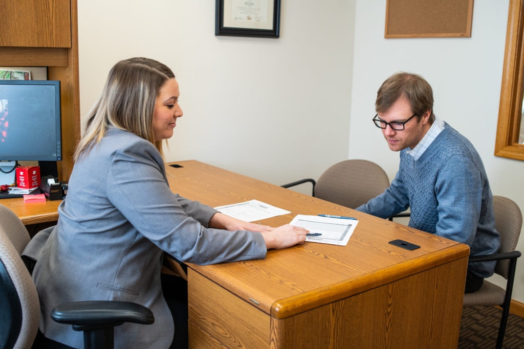 A bank manager going over a bank loan with a customer.