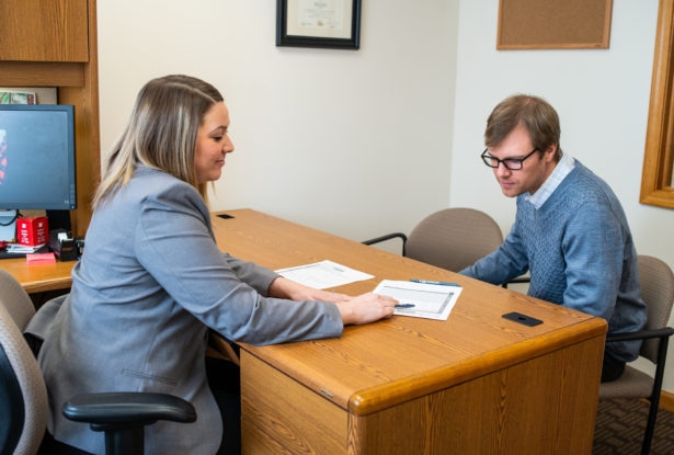 A bank manager going over a bank loan with a customer.
