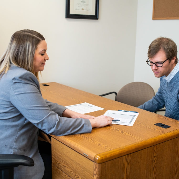 A bank manager going over a bank loan with a customer.