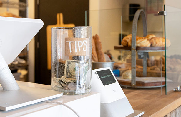 Tips jar at a bakery on the counter.