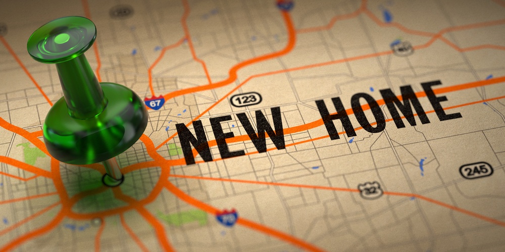 New Home Concept - Green Pushpin on a Map Background with Selective Focus.