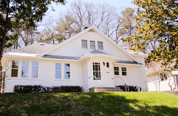 Beautiful white home sitting up on a hill