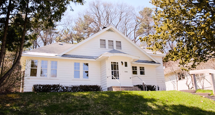 Beautiful white home sitting up on a hill