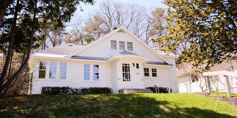 Beautiful white home sitting up on a hill