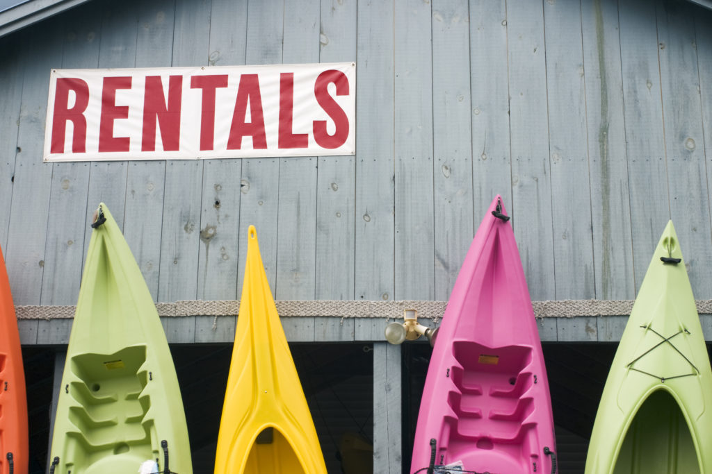 Kayaks standing outside a a kayak and canoe rental business