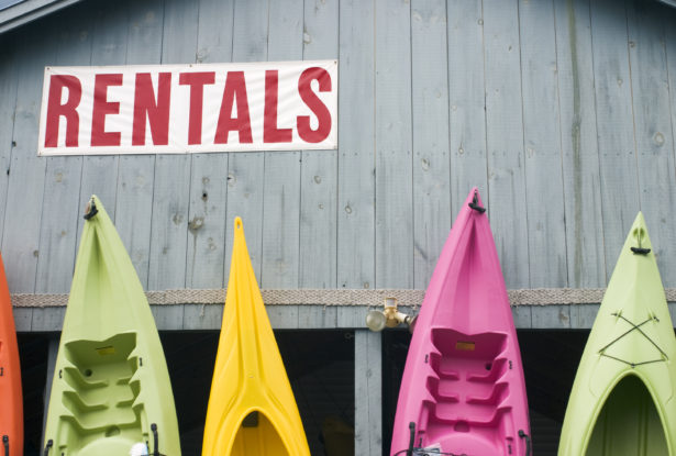 Kayaks standing outside a a kayak and canoe rental business