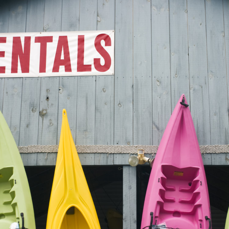Kayaks standing outside a a kayak and canoe rental business