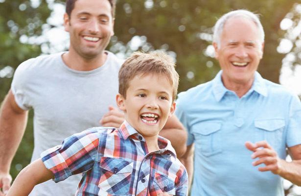 Happy family running outside on a summer day