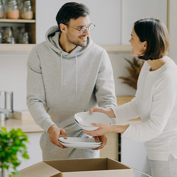 Couple Unpacking dishes at new house