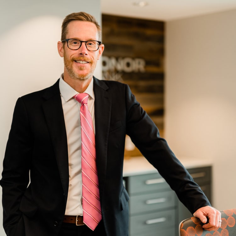 Norm Plumstead President and CEO of Honor Bank Smiling at his office