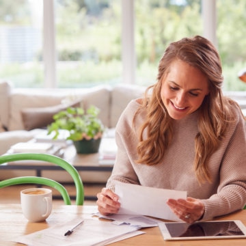 Woman Happy Reviewing Personal Loan Documents