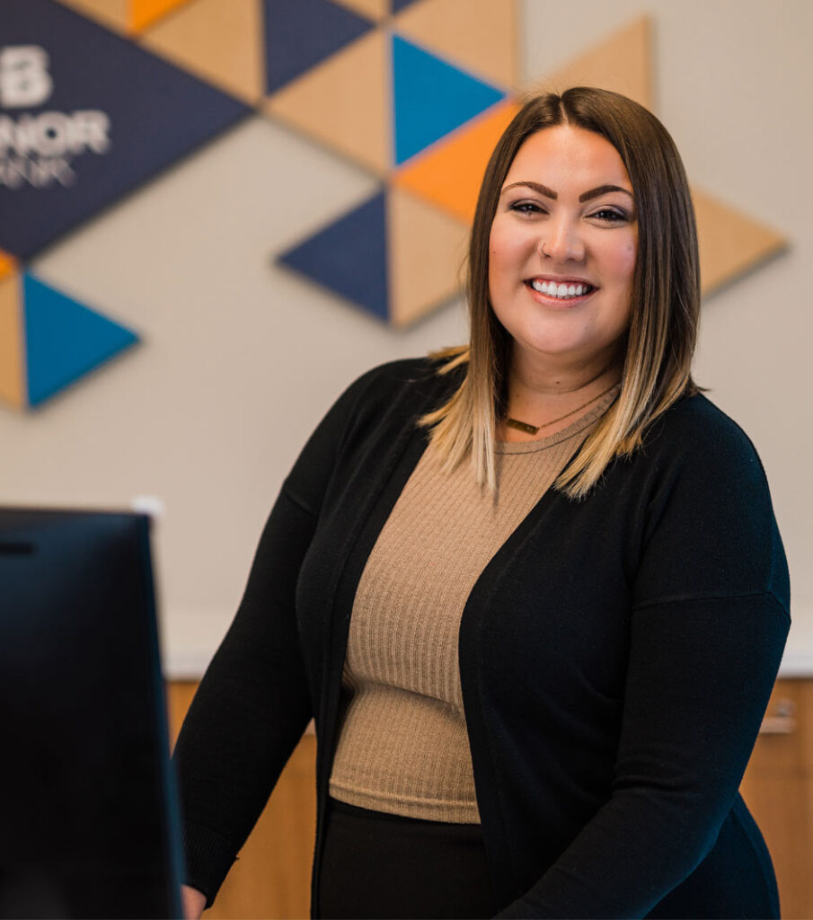 A bank worker smiling and giving off warm greeting